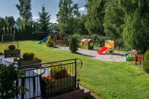 a park with a playground with a play area at DW Róża Wiatrów in Dębki