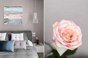 グダニスクにあるOld Town - River Point by Welcome Apartmentのベッド1台とピンクのバラが備わるお部屋