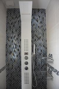 a bathroom with a shower with tiled walls at Villa Les Anges in Saint-Andre-de-la-Roche