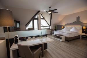 a bedroom with a bed with a ceiling fan at Hotel Traumblick in Cochem