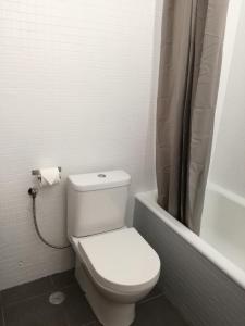 ヴィラモウラにあるGOLDEN loftの白いバスルーム(トイレ、シャワーカーテン付)
