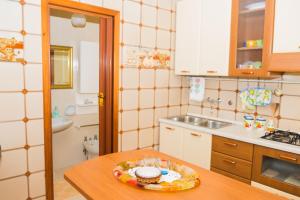 a kitchen with a table with a plate of food on it at Giulia e Pietro - Marettimo Apartments in Marettimo +63 photos