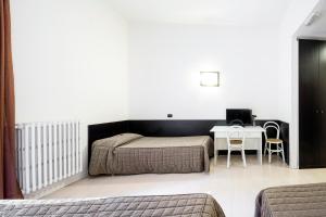 Llit o llits en una habitació de Hotel Colucci