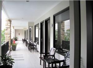 a row of chairs sitting on a balcony at Bintang Mulia Hotel & Resto in Jember