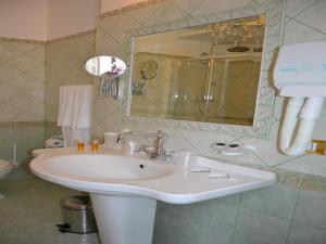 een badkamer met een wastafel en een spiegel bij Sleep In Rome Ludovisi in Rome