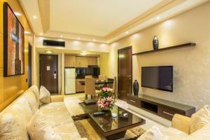 ein Wohnzimmer mit Sofa und Fernseher in der Unterkunft Imperial Suites Hotel in Beirut