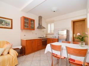 a kitchen with a table and a couch in a room at Studio in Vinkuran - Istrien 11043 in Vinkuran