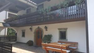 a house with a wooden table and a balcony at Apartments Dolar in Bled