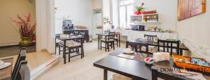 a restaurant with tables and chairs and a counter at Domus Alberti Bed & Breakfast in Rome