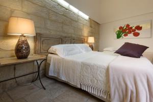 Postel nebo postele na pokoji v ubytování Palazzo Dei Dondoli