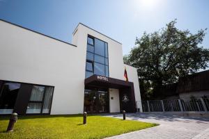a white building with a hotel sign on it at Hotel Babilonas in Kaunas