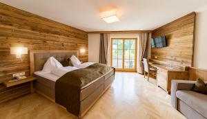 a hotel room with a bed and a sink at Landhotel Drei Eichen in Eugendorf +56 photos