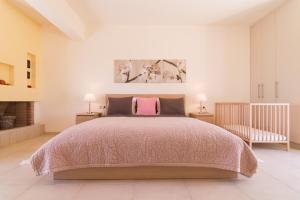 a bedroom with a large bed and two lamps at Athena Villas Olive Grove & Estate in Gouves