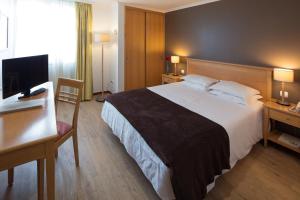 Een bed of bedden in een kamer bij Hotel Orquidea