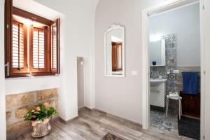 a bathroom with a mirror and a sink at Le Alcove in Cinisi