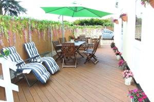 a patio with chairs and a table with an umbrella at The Homestar in Skegness