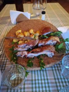a sandwich with meat and vegetables on a table at Bed and breakfast sas Damas in Chiaramonti