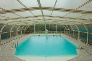 an indoor swimming pool with a glass ceiling at Le Clos des Cèdres b&b in La Rochefoucauld +44 photos