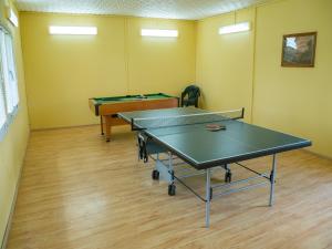 two ping pong tables in a room with yellow walls at Filkówka- Słoneczne Wzgórze in Wadowice