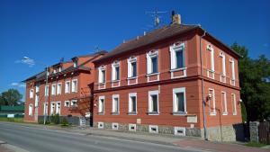 a large red building on the side of a street at Casino Admiral Velenice - Gmünd in České Velenice