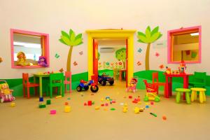 a room with toys on the floor in front of a room with trees at Martı Myra - Ultra All Inclusive in Tekirova