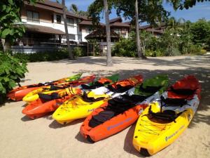 a group of kayaks lined up on the beach at Maehaad Bay Resort - SHA Plus in Mae Haad