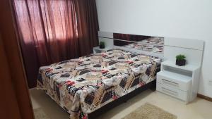En eller flere senge i et værelse på Tramandaí Sunrise Residence