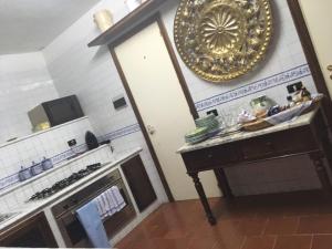 a kitchen with a stove and a plate on the wall at Casa Felice in Ravello