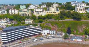 a large building with a clock on top of it at Astor House in Torquay