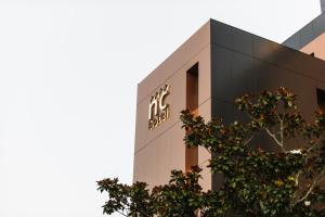 a building with a sign on the side of it at Nova Cruz Hotel in Santa Maria Da Feira