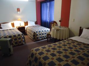 Postel nebo postele na pokoji v ubytování Hotel T'ika