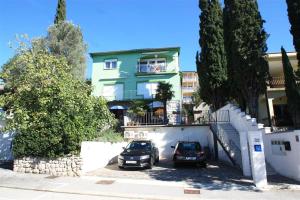 two cars parked in a parking lot in front of a building at One-Bedroom Apartment Crikvenica 47 in Dramalj