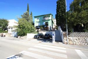 a house with a car parked in front of it at One-Bedroom Apartment Crikvenica 47 in Dramalj