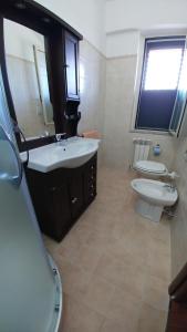a bathroom with two sinks and a toilet in it at Bruno B&B in Cropani