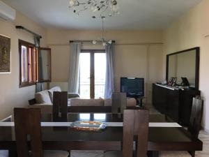 a living room with a table and a couch at Family Cozy House Nafplio in Nafplio