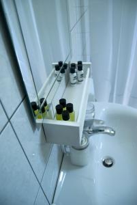 a bathroom with a sink with some bottles on it at Naxos olive & home in Engares