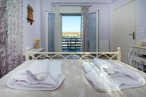 Posteľ alebo postele v izbe v ubytovaní Avlemonas Bay Sea Houses.