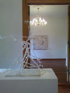 a sculpture of a tree on a table with a chandelier at Residenz Villa Kult in Berlin
