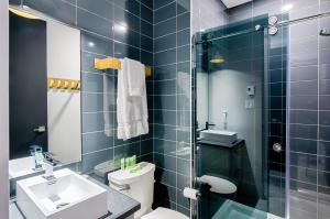 een badkamer met een toilet, een wastafel en een douche bij Les Lofts Notre-Dame - Par Les Lofts Vieux-Québec in Québec