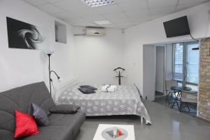 a living room with a bed and a couch at Apartments Qualitas in Kotor