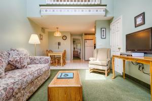 a living room with a couch and a table at Misty Harbor Resort in Wells