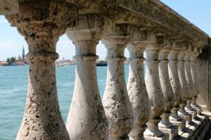 a row of columns on a bridge over water at Appartamento Calle dei Preti in Venice