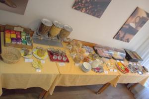 a table with plates and bowls on top of it at Hotel Atrium in Vyškov