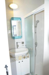 a bathroom with a sink and a toilet and a mirror at The Stable in Limassol