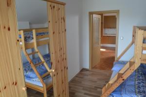 a room with two bunk beds and a hallway at Ubytovani U Ruzenky in Velké Bílovice
