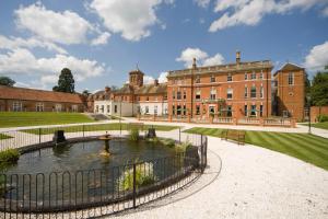 a large building with a fountain in front of it at Oakley Hall Hotel in Basingstoke