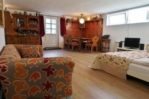 a bedroom with a bed and a couch and a table at Austria Center - Wien an der Donau in Vienna