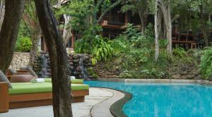a resort with a swimming pool and a resort at The Deer Park Hotel in Giritale