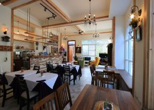 a restaurant with tables and chairs in a room at La Fleur BnB & Restaurant in Hengchun South Gate