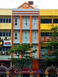 un bâtiment orange et blanc dans une ville dans l'établissement Hotel Check-In, à Kuala Lumpur